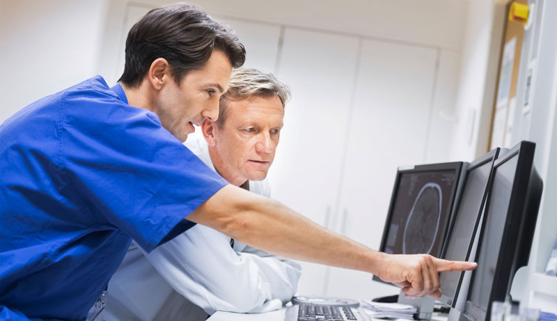 Doctors looking at computer monitor